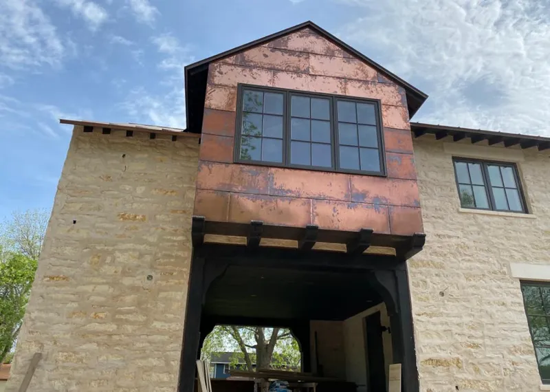 Copper metal panel facade on a stone building for Skylight Installation in Prosser